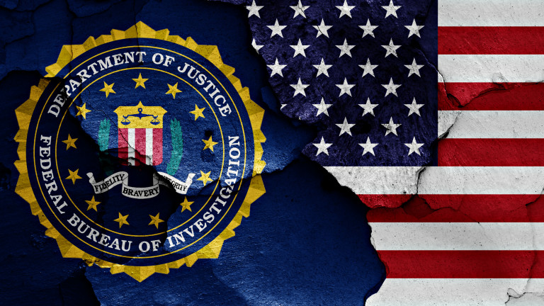 flag of FBI and USA painted on cracked wall