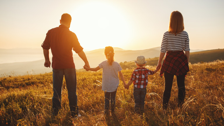 Happy family: mother, father, children son and daughter on sunset