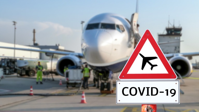 Airplane at the airport warning sign coronavirus